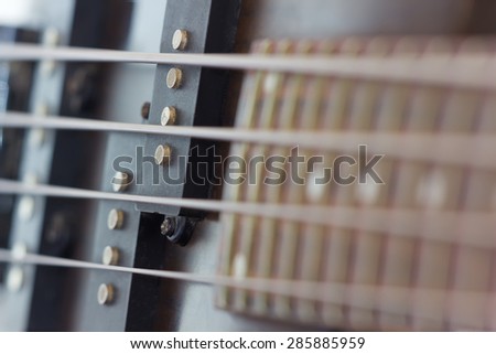 macro picture of strings and pickups of bass guitar