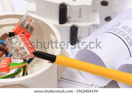 Electrical box with connections of electric copper wires, electric fuse and housing plan. Components using in electrical installations. Accessories for engineering work