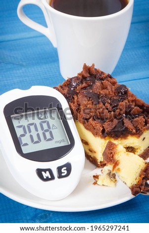 Glucometer with bad result of measurement sugar level and fresh baked cheesecake with black coffee. Dieting during diabetes