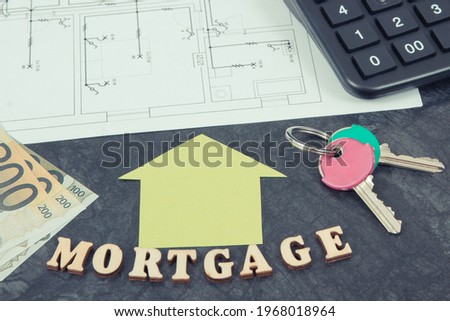 Inscription mortgage, currencies euro, home keys and calculator on electrical diagrams, calculations of buying house concept