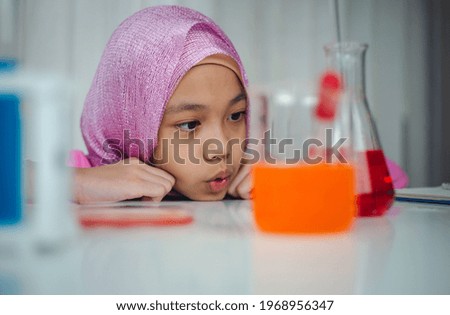 Muslim girl in elementary school in a science lab experiment, Islamic kindergarten students in a lab scientist, Kids and education concepts