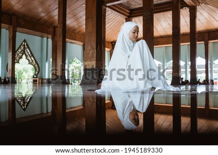 Asian Muslim girls kneel down worship and prays for Allah