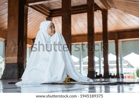 Asian Muslim girls kneel down worship and prays for Allah