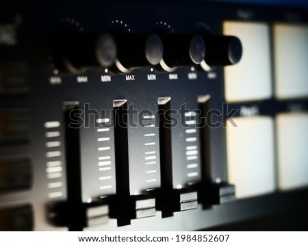 A dramatic shot of drum pad controller buttons lit with white light