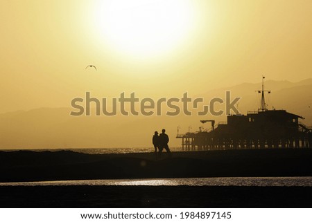 A landscape of the Santa Monica Beach silhouette during the sunset in California, the USA