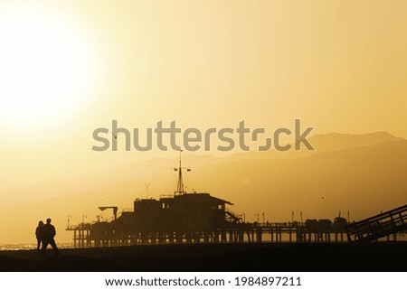 A landscape of the Santa Monica Beach silhouette during the sunset in California, the US
