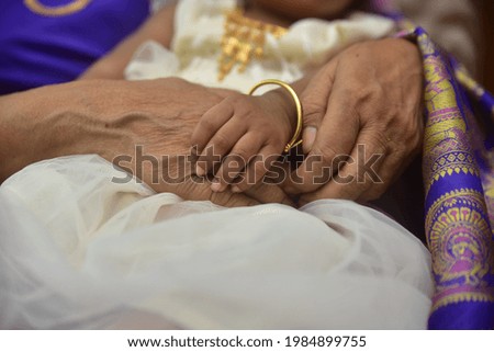 Asian parent hands holding newborn baby fingers, Close up mother's hand holding their new born baby  Family ove