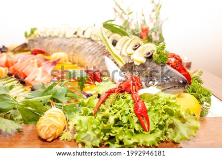 Served whole cut fish with fresh fruit on a plate