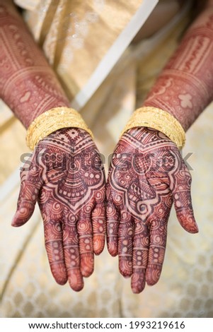 Bride\'s hands showing henna (mehndi) tattoos at Hindu wedding