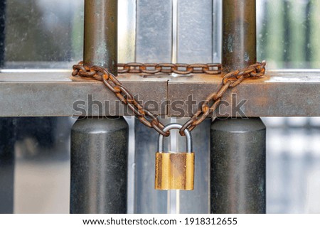 Rusty Chain and Locked Padlock at Bars Safety