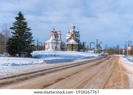 Two old churches by the road in the winter landscape. Paltoga, Vologda Oblast. Russia