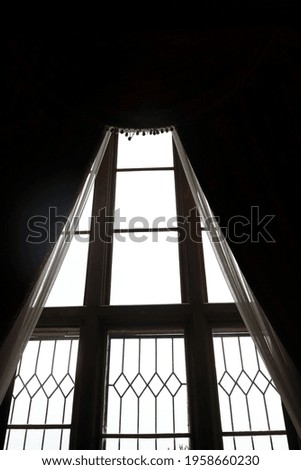 Part of window with curtains in old mansion