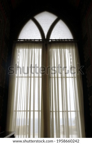Details of window with curtains in old mansion