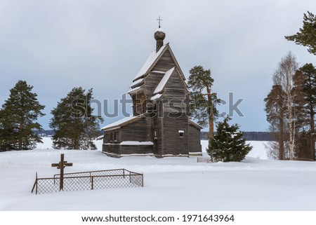 View of the old wooden church of St. George the Victorious (1522) on a gloomy February day. Rodionovo (Yuksovichi). Leningrad region, Russia