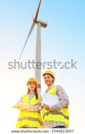 Engineers on windmill farm for electric power production