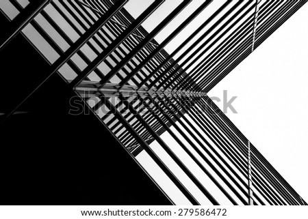 Urban Geometry, looking up to glass building. Modern architecture black and white, glass and steel. X marks the spot. Abstract architectural design. Inspirational, artistic image BW.
