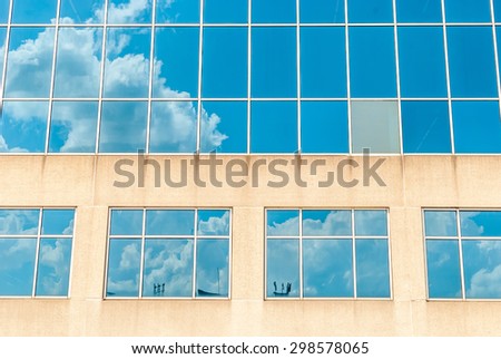 Glass building cloud reflections. Blue sky background. Modern building. Modern office building. Glass reflection of sky. Abstract art. Modern architecture. Modern glass building. Abstract design. Art,