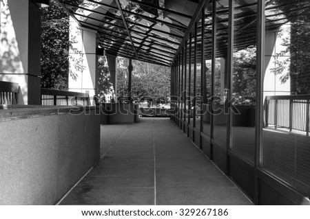 Modern office building exterior in black and white. Window reflections of glass building interior. Modern art architecture design. Urban geometry. Minimal architecture design.
