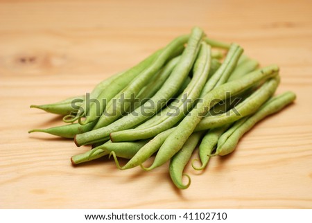 French Beans on wooden surface. Soft focus.