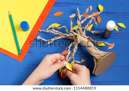 How to make together with child autumn tree from craft package. Original children\'s art project. DIY concept. Step-by-step photo instructions. Step 9. Glue leaves of tree