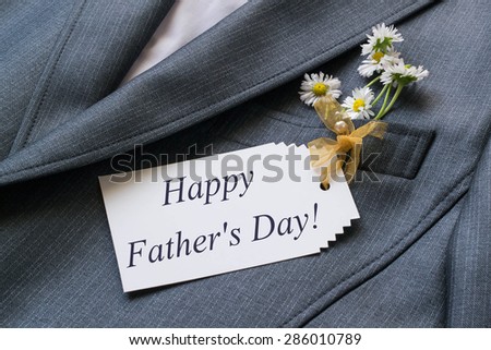 Surprise for Father\'s day: wish a happy Father\'s Day on the card and chamomile in a jacket pocket