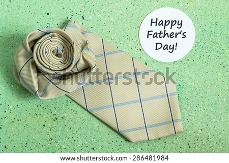 Decoration idea for Father\'s day -  tie in the shape of a rose and a sticker with the words: Happy Father\'s Day on a green colored background