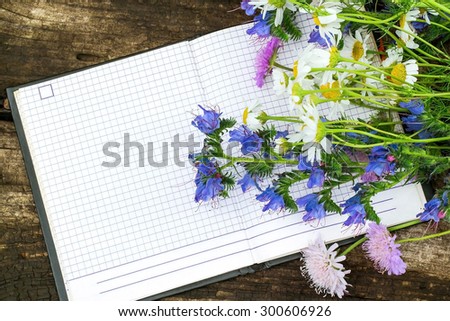 Beautiful wildflowers and a notebook to record with free space for text. Good for holiday greetings