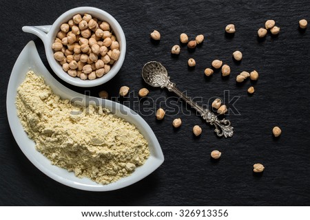 Source of vitamins A, E, groups B, manganese, calcium, selenium - chickpeas and chickpea gluten-free flour on a slate surface