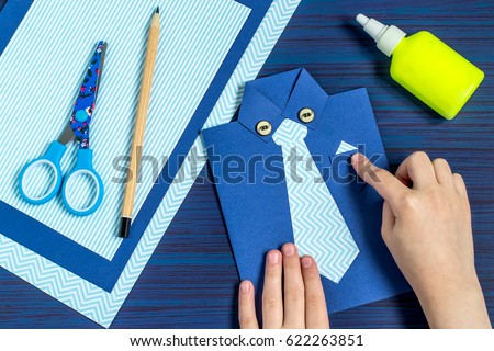 Making greeting card for Father's Day. Children's art project. DIY concept. Step-by-step photo instruction. Step 9. Child glues pocket and buttons