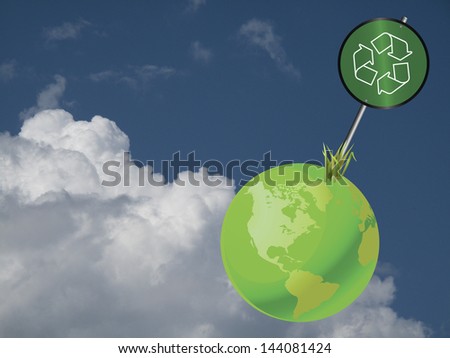 Green earth recycling sign against a cloudy blue sky