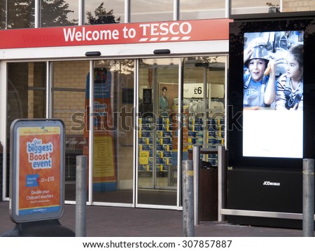 Feltham, London, Middlesex, England - August 19, 2015: Tesco supermarket main entrance to store, company founded by Jack Cohen in 1919