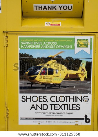 Andover, River Way, Hampshire, England - August 29, 2015: Air ambulance clothing charity recycling collection bin Tesco Extra Superstore