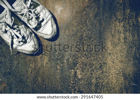 Old shoes.Old background. Dirty shoes. Grunge style