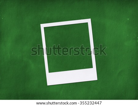 Instant photo frame on green background. Polaroid photo frame