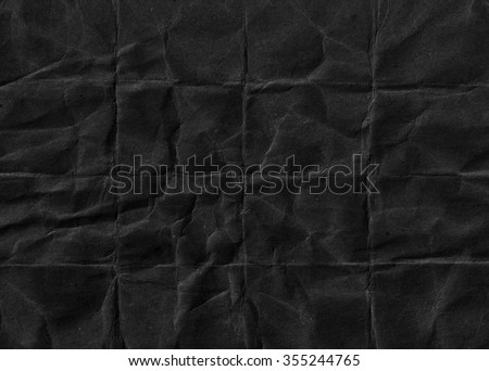 Black crumpled paper. Black background. Grunge paper