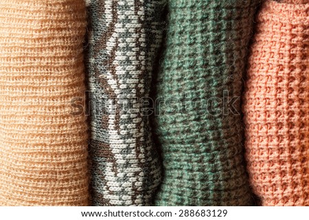 Knitted texture background. A stark of sweaters. Vintage cloth. Hipster wardrobe. Fabric textures. Stylish cloth. Shoping background.
