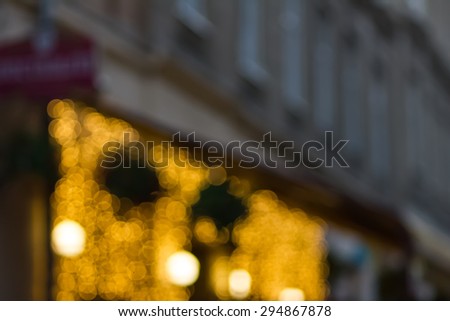 Blurred background night photo. Cityscape bokeh. De-focused abstract city. Background out of focus. Can use as wallpaper, design. Summer blurry city backdrop. Fairy de-focused photos.
