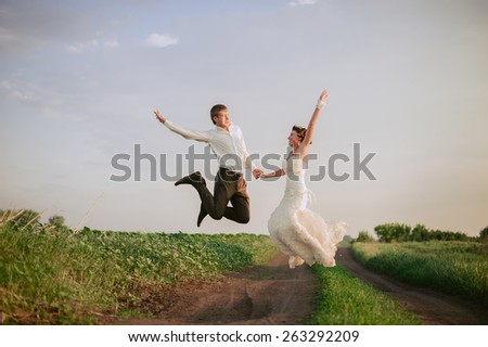 Happy bride and groom enjoying their wedding day in green nature
