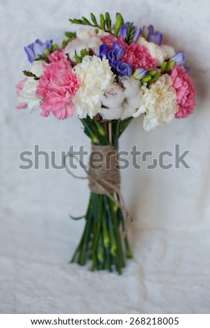 Beautiful bridal bouquet of white, pink and purple flowers on a white background