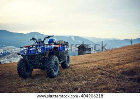 ATV Quad Bike in front of mountains landscape. Selective focus