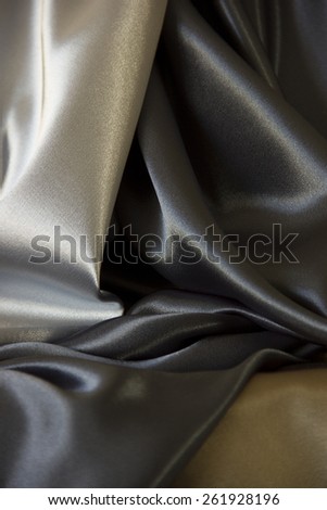 Drape of silver, blue black and field drab silk fabrics