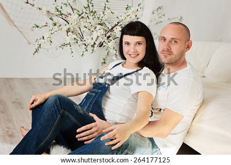 Pregnant woman with her loving husband in a happy anticipation of the baby
