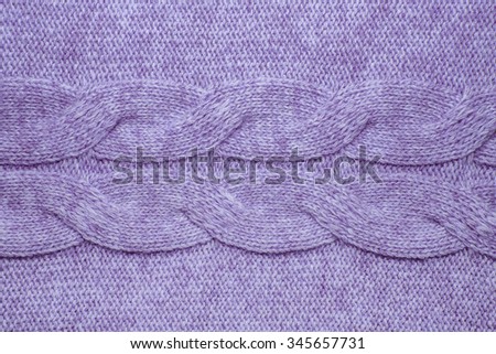 Wool sweater texture close up. Knitted jersey background with a relief pattern. Braids in machine knitting pattern