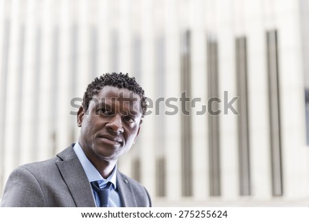 Attractive black businessman with suit and tie looking and thinking