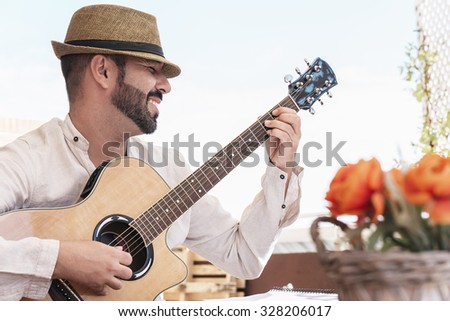 man plays the guitar on the street. retro style. feel the music