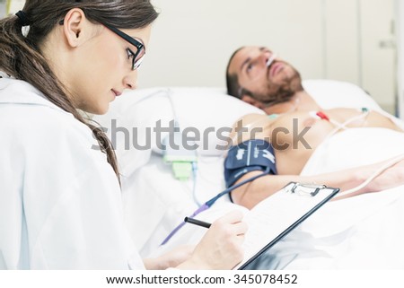 Doctor is caring a sick man in hospital