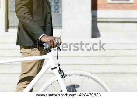 Handsome african man on bike in the city. Bicycle concept