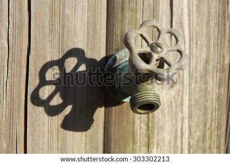 Dry Water Faucet Casting a Shadow on a Wooden Wall (Rockport, Massachusetts, USA / June 7, 2015)