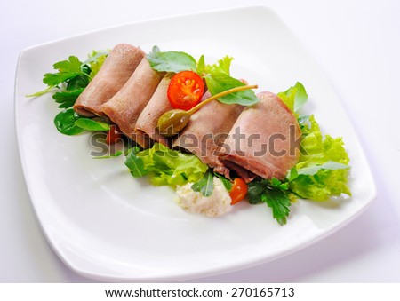 beef tongue served with greens