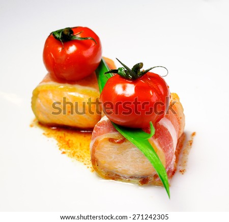 snack from the salmon wrapped in bacon with a cherry tomato